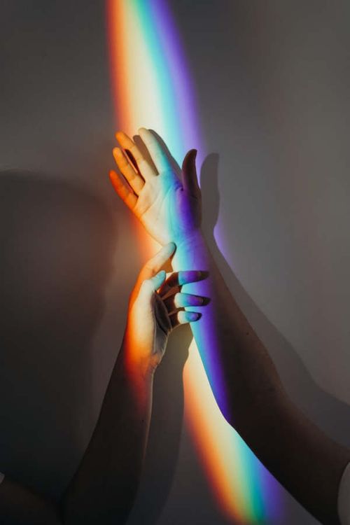 Two hands with a rainbow